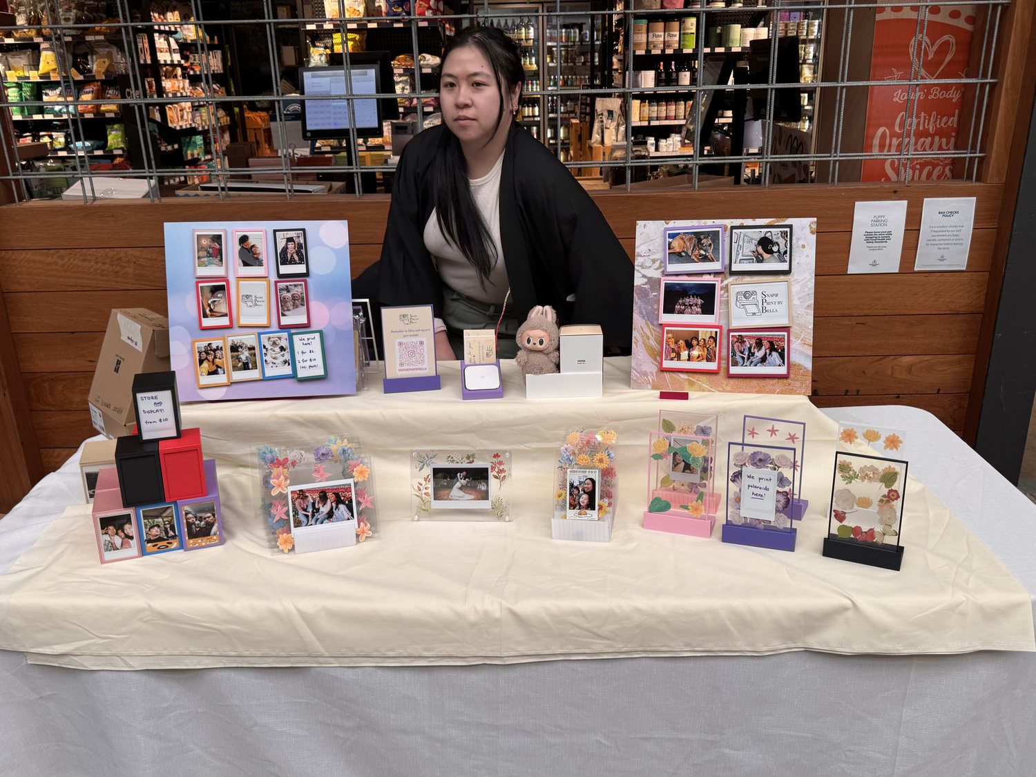 The Snap and Print stall, laid out with framed prints and decorated frames.